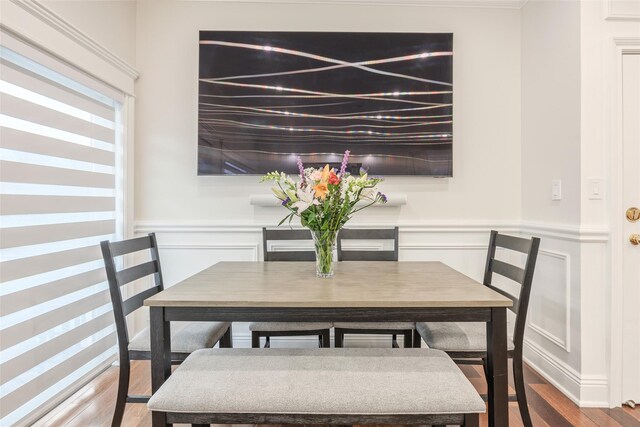 114 Atlantic Ave Unit 82, Lynbrook, NY 11563 - dining area featuring wood finished floors, a wainscoted wall, and a decorative wall
