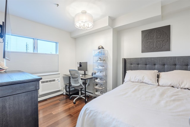 114 Atlantic Ave Unit 82, Lynbrook, NY 11563 - bedroom with dark wood-type flooring, an office area, a chandelier, and a baseboard radiator