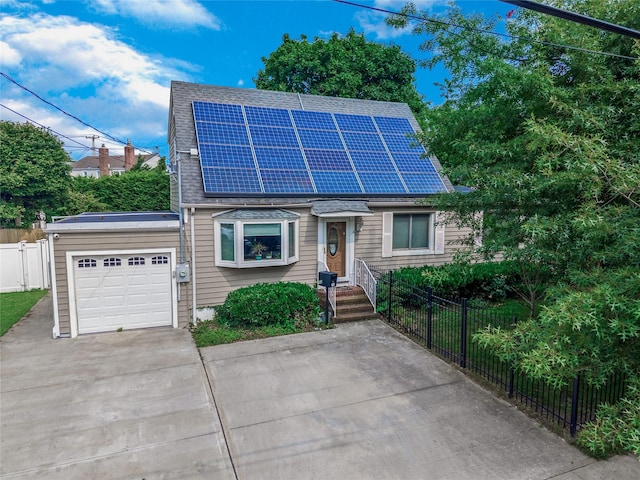72 Harris Ave, Hewlett, NY 11557 - view of front facade with roof mounted solar panels, driveway, a garage, and a shingled roof