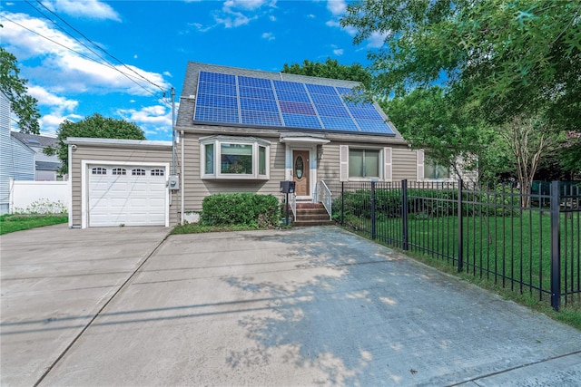72 Harris Ave, Hewlett, NY 11557 - view of front of home with concrete driveway, a garage, solar panels, and roof with shingles