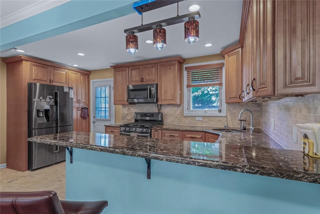 72 Harris Ave, Hewlett, NY 11557 - kitchen featuring stainless steel appliances, dark stone counters, a breakfast bar area, tasteful backsplash, and a peninsula