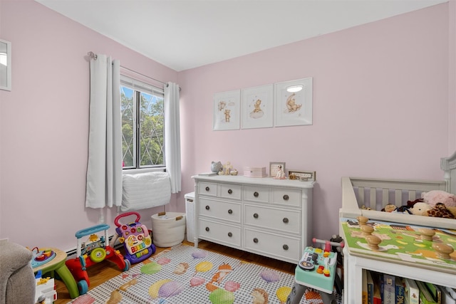 129 Main St Unit D12, Cornwall, NY 12518 - bedroom featuring dark wood finished floors and a baseboard radiator
