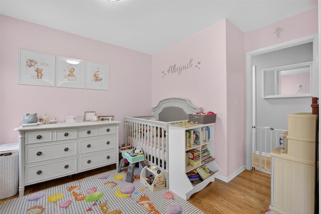 129 Main St Unit D12, Cornwall, NY 12518 - bedroom with wood finished floors and a nursery area