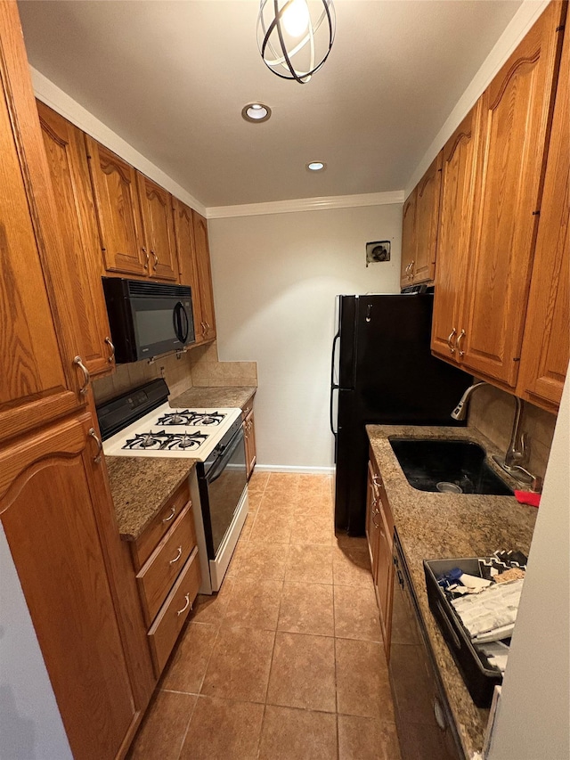 596 Broadway Unit 10A, Lynbrook, NY 11563 - kitchen with white range with gas cooktop, black microwave, brown cabinets, ornamental molding, and light tile patterned flooring