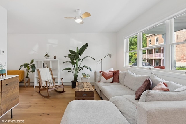 50 N Chestnut St, Beacon, NY 12508 - living room with light wood-style flooring, a ceiling fan, and baseboard heating