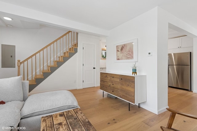 50 N Chestnut St, Beacon, NY 12508 - living area with electric panel, stairway, and light wood-style flooring