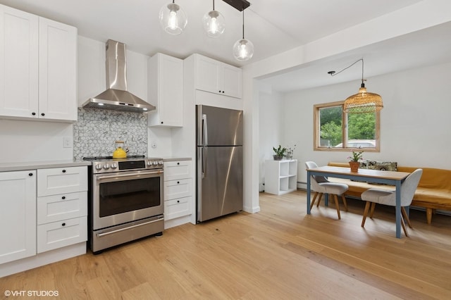 50 N Chestnut St, Beacon, NY 12508 - kitchen with appliances with stainless steel finishes, wall chimney exhaust hood, decorative backsplash, light wood-style flooring, and white cabinetry