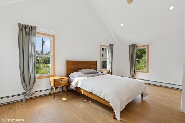 50 N Chestnut St, Beacon, NY 12508 - bedroom with a baseboard heating unit, wood finished floors, high vaulted ceiling, and recessed lighting