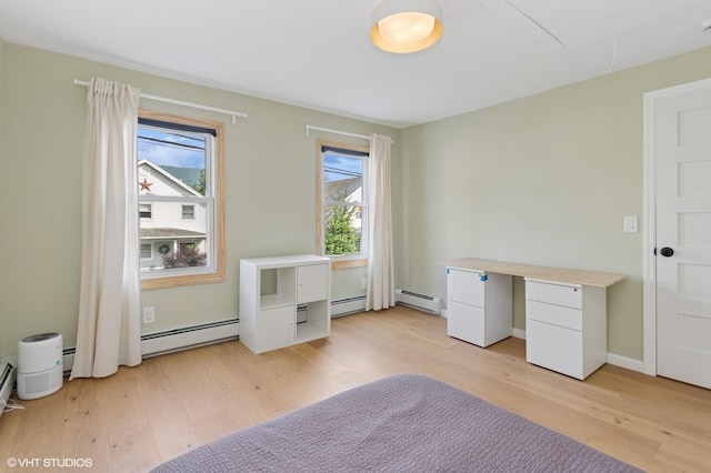 50 N Chestnut St, Beacon, NY 12508 - unfurnished bedroom featuring a baseboard heating unit, light wood-style flooring, and attic access