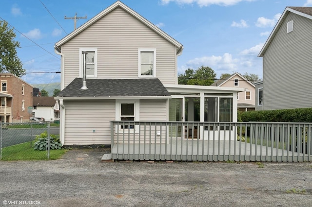 50 N Chestnut St, Beacon, NY 12508 - rear view of property featuring a sunroom and roof with shingles