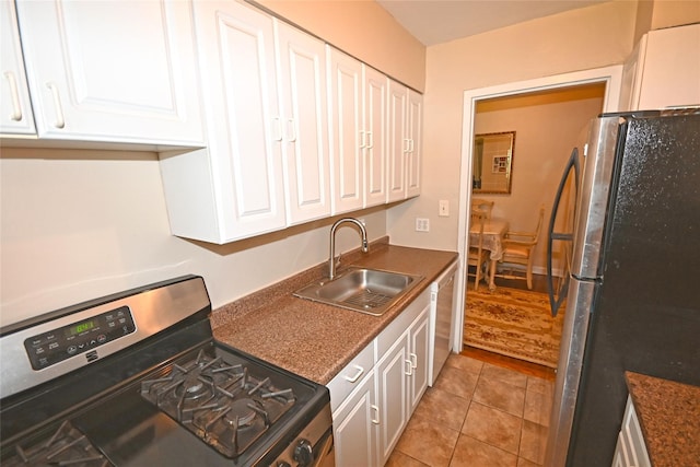 221 Middle Neck Rd Unit I-3, Great Neck, NY 11021 - kitchen with stainless steel appliances, white cabinetry, dark countertops, and light tile patterned flooring