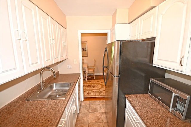 221 Middle Neck Rd Unit I-3, Great Neck, NY 11021 - kitchen featuring appliances with stainless steel finishes, dark countertops, and white cabinetry