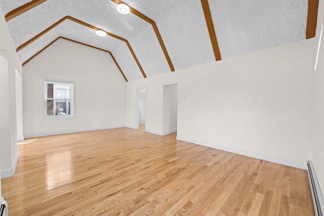 131-36 Francis Lewis Blvd, Laurelton, NY 11413 - unfurnished living room with a baseboard radiator, light wood finished floors, and lofted ceiling