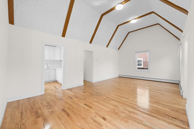131-36 Francis Lewis Blvd, Laurelton, NY 11413 - bonus room featuring baseboard heating, a textured ceiling, vaulted ceiling, and light wood finished floors