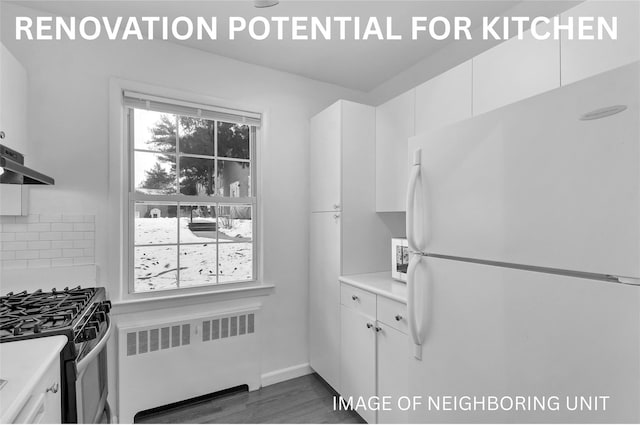 182 Pinewood Rd Unit 28, Hartsdale, NY 10530 - kitchen with freestanding refrigerator, radiator, gas range, white cabinets, and light countertops