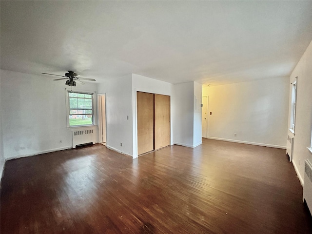 182 Pinewood Rd Unit 28, Hartsdale, NY 10530 - unfurnished living room featuring radiator heating unit, dark wood-type flooring, and ceiling fan