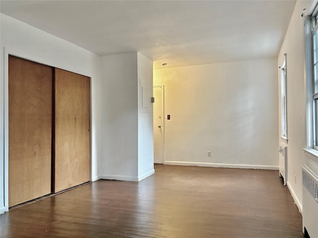 182 Pinewood Rd Unit 28, Hartsdale, NY 10530 - unfurnished bedroom featuring radiator heating unit, dark wood-style flooring, and a closet