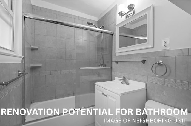 182 Pinewood Rd Unit 28, Hartsdale, NY 10530 - full bathroom with vanity, tile walls, and bath / shower combo with glass door