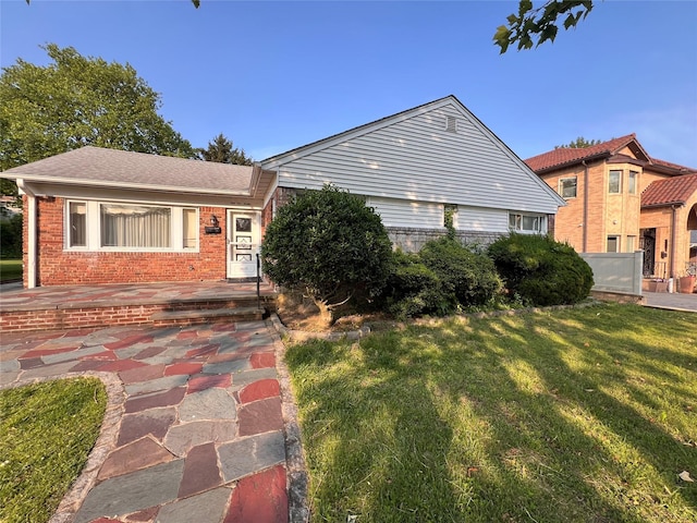 64-19 Marathon Pkwy, Little Neck, NY 11362 - view of front facade featuring brick siding and a front lawn