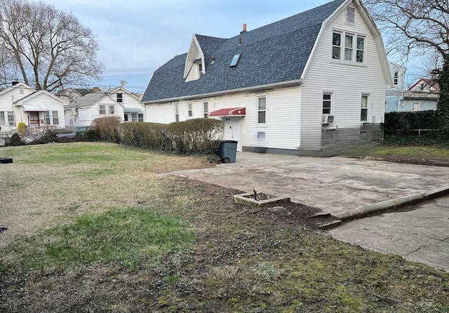 14 Matthews Pl, Brooklyn, NY 11236 - view of side of property featuring roof with shingles, a yard, and a gambrel roof