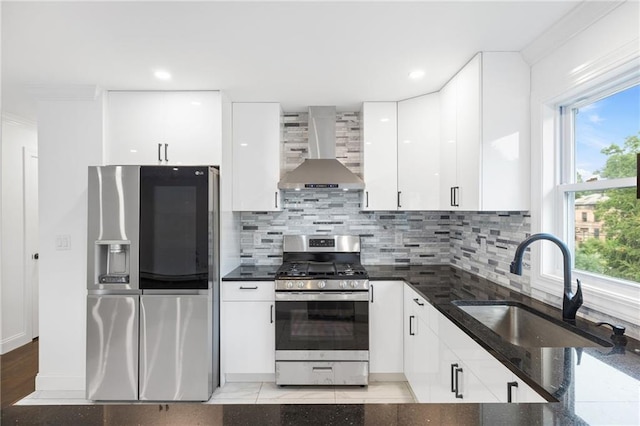 52 Broadway, Piermont, NY 10968 - kitchen featuring wall chimney range hood, stainless steel appliances, white cabinets, decorative backsplash, and plenty of natural light