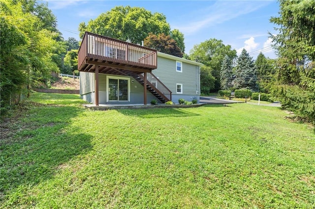 52 Broadway, Piermont, NY 10968 - rear view of house with stairs, a wooden deck, and a lawn