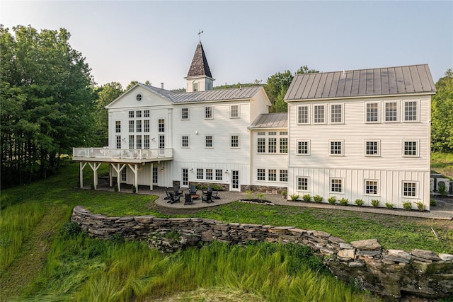 1174 Potter Mountain Rd, Gilboa, NY 12076 - back of property featuring a patio, a standing seam roof, a deck, and a yard