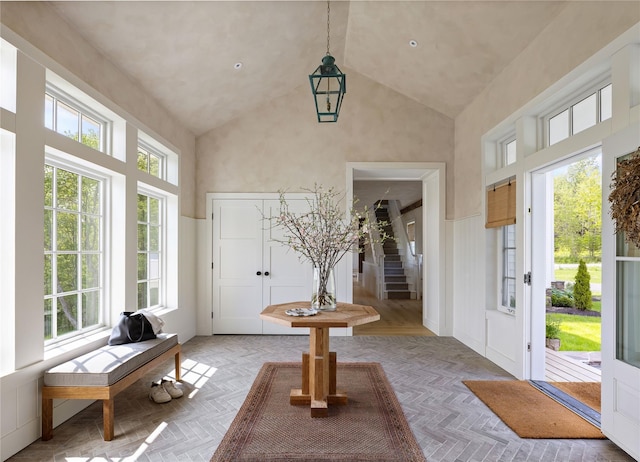 1174 Potter Mountain Rd, Gilboa, NY 12076 - entryway featuring high vaulted ceiling, plenty of natural light, stairs, and a decorative wall