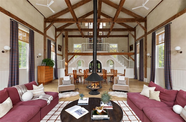 1174 Potter Mountain Rd, Gilboa, NY 12076 - living area with high vaulted ceiling, stairs, wood finished floors, wainscoting, and beam ceiling