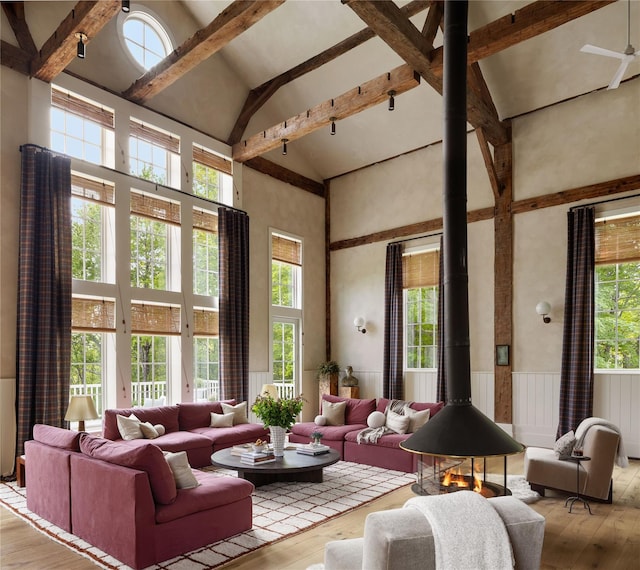 1174 Potter Mountain Rd, Gilboa, NY 12076 - living area featuring a wood stove, high vaulted ceiling, wood-type flooring, plenty of natural light, and beamed ceiling