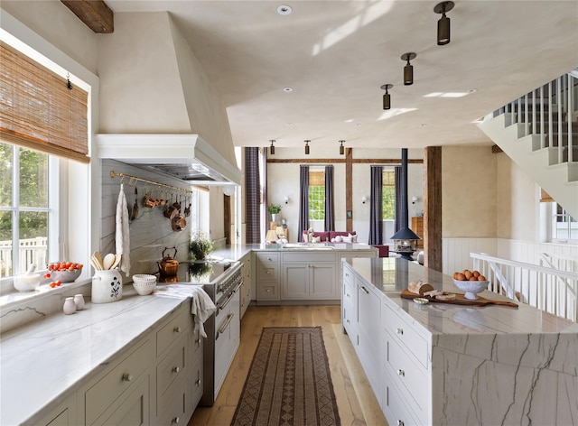 1174 Potter Mountain Rd, Gilboa, NY 12076 - kitchen featuring a wood stove, healthy amount of natural light, light wood-type flooring, and light stone counters
