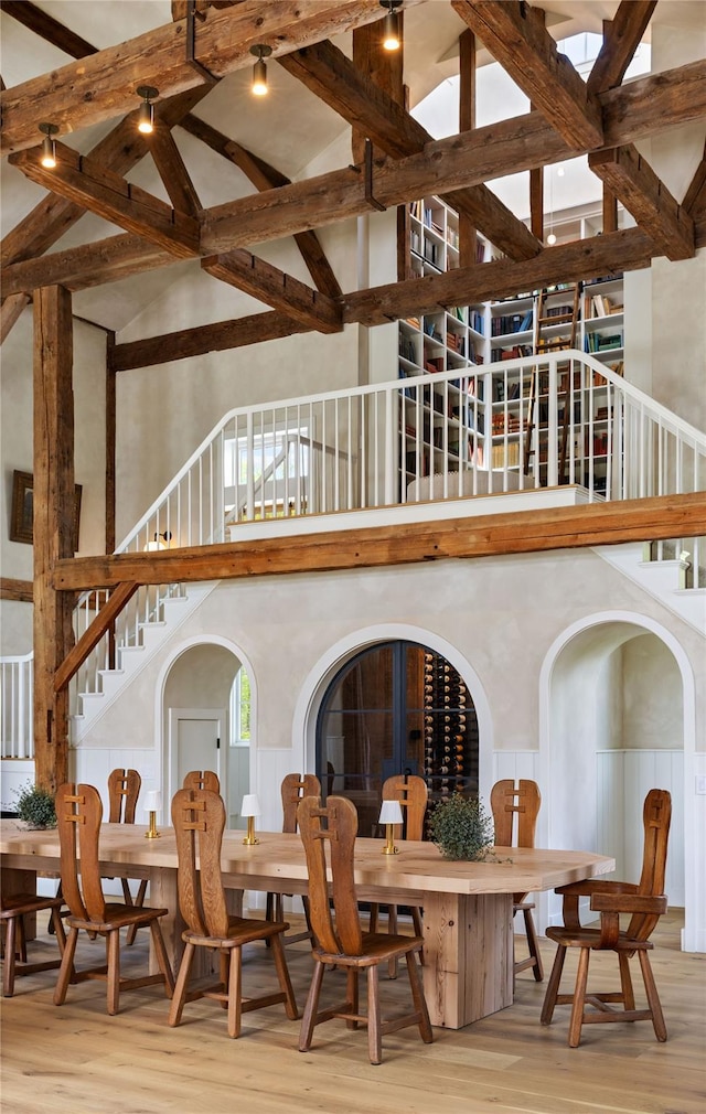 1174 Potter Mountain Rd, Gilboa, NY 12076 - dining room with high vaulted ceiling, stairway, wood finished floors, a wainscoted wall, and beamed ceiling