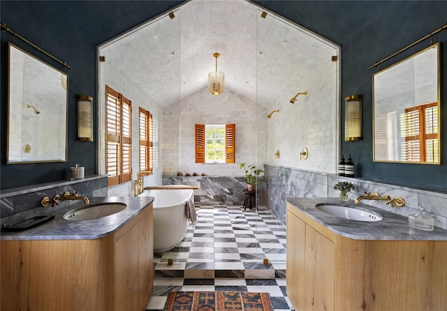 1174 Potter Mountain Rd, Gilboa, NY 12076 - bathroom with tile walls, vaulted ceiling, two vanities, a freestanding tub, and a wainscoted wall