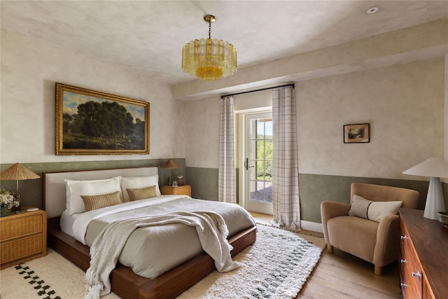 1174 Potter Mountain Rd, Gilboa, NY 12076 - bedroom featuring access to outside, wood finished floors, and a chandelier