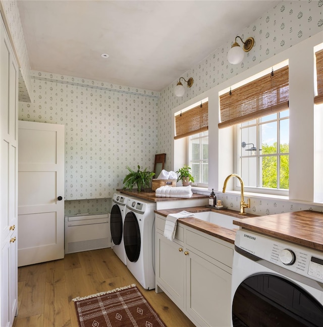 1174 Potter Mountain Rd, Gilboa, NY 12076 - laundry area with independent washer and dryer, wallpapered walls, light wood finished floors, and cabinet space