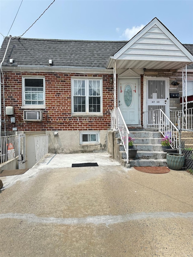 4732 207th St, Bayside, NY 11361 - townhome / multi-family property featuring roof with shingles and brick siding