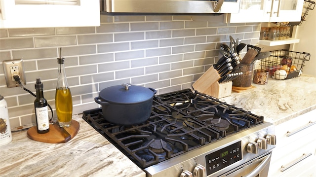 445 Gramatan Ave Unit Hc2, Mount Vernon, NY 10552 - kitchen view of gas stove, decorative backsplash, light stone countertops, and white cabinetry