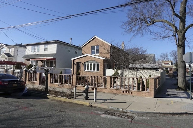 12902 145th St, Jamaica, NY 11436 - view of front of property featuring brick siding and a fenced front yard