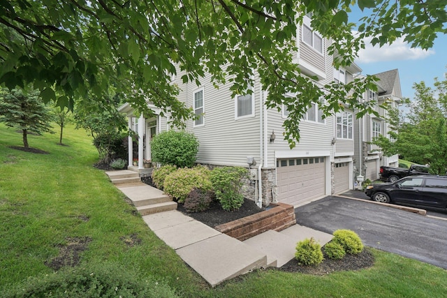 2602 Hawthorn Way, New Windsor, NY 12553 - view of side of property featuring a garage, asphalt driveway, a yard, and stone siding