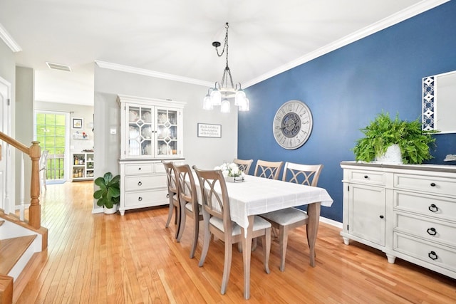 2602 Hawthorn Way, New Windsor, NY 12553 - dining space featuring light wood-type flooring, stairs, a chandelier, and crown molding