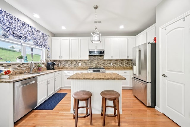 2602 Hawthorn Way, New Windsor, NY 12553 - kitchen with stainless steel appliances, a center island, backsplash, white cabinets, and recessed lighting
