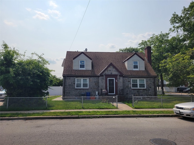 122 James St, Franklin Square, NY 11010 - cape cod home with stone siding, a chimney, and a fenced front yard