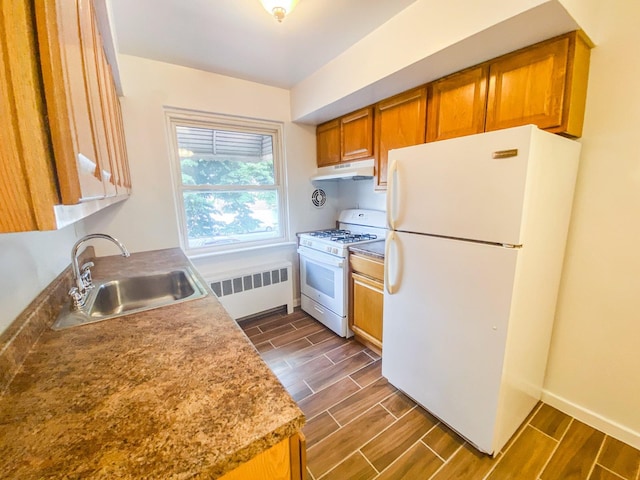 1365 Crosby Ave, Bronx, NY 10461 - kitchen with white appliances, radiator, under cabinet range hood, and wood finish floors