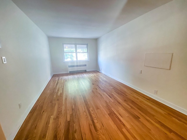 1365 Crosby Ave, Bronx, NY 10461 - empty room with radiator heating unit and light wood-type flooring