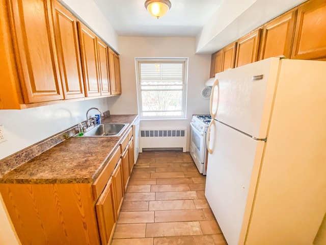 1365 Crosby Ave, Bronx, NY 10461 - kitchen featuring white appliances, radiator, brown cabinets, and dark countertops