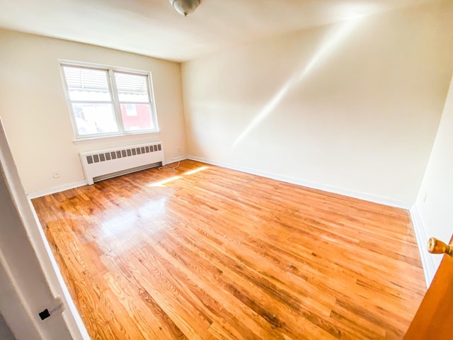 1365 Crosby Ave, Bronx, NY 10461 - unfurnished room featuring radiator heating unit and wood finished floors