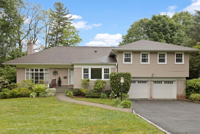 8 Sylvan Ln, Scarsdale, NY 10583 - tri-level home featuring a chimney, driveway, brick siding, and a front lawn