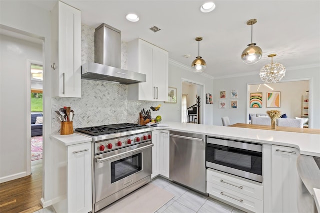 8 Sylvan Ln, Scarsdale, NY 10583 - kitchen with appliances with stainless steel finishes, wall chimney range hood, light countertops, tasteful backsplash, and white cabinetry