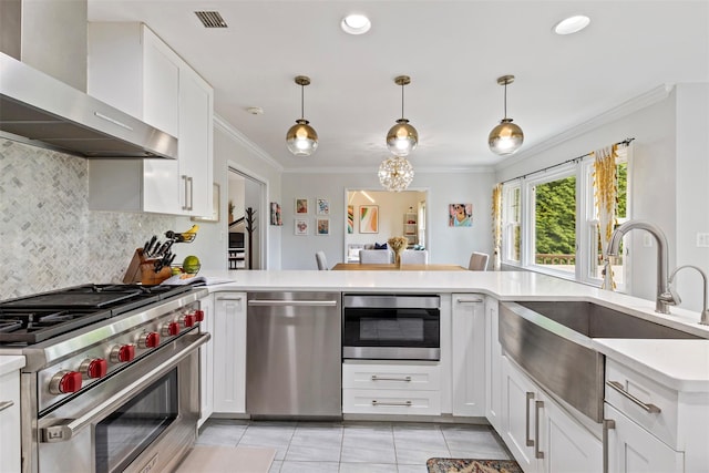 8 Sylvan Ln, Scarsdale, NY 10583 - kitchen featuring wall chimney range hood, stainless steel appliances, crown molding, light countertops, and tasteful backsplash