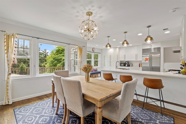 8 Sylvan Ln, Scarsdale, NY 10583 - dining space with ornamental molding, a chandelier, recessed lighting, and dark wood-type flooring